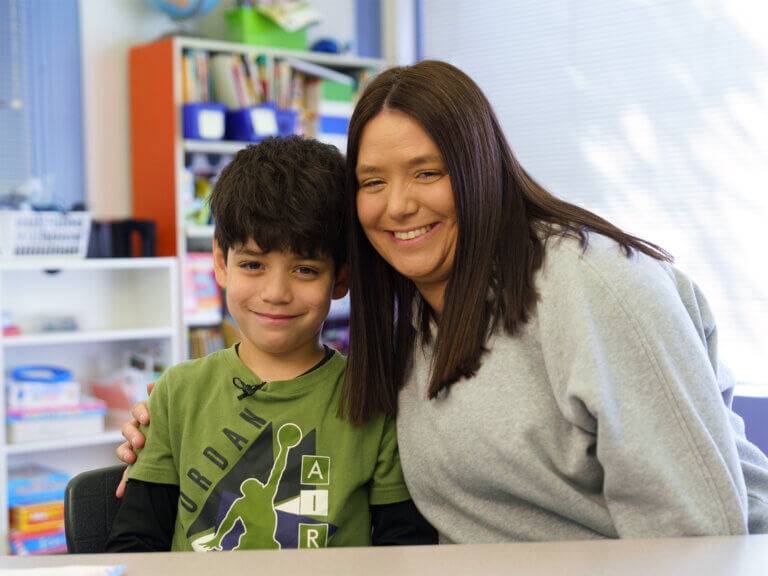 A mother and son together at a classroom table