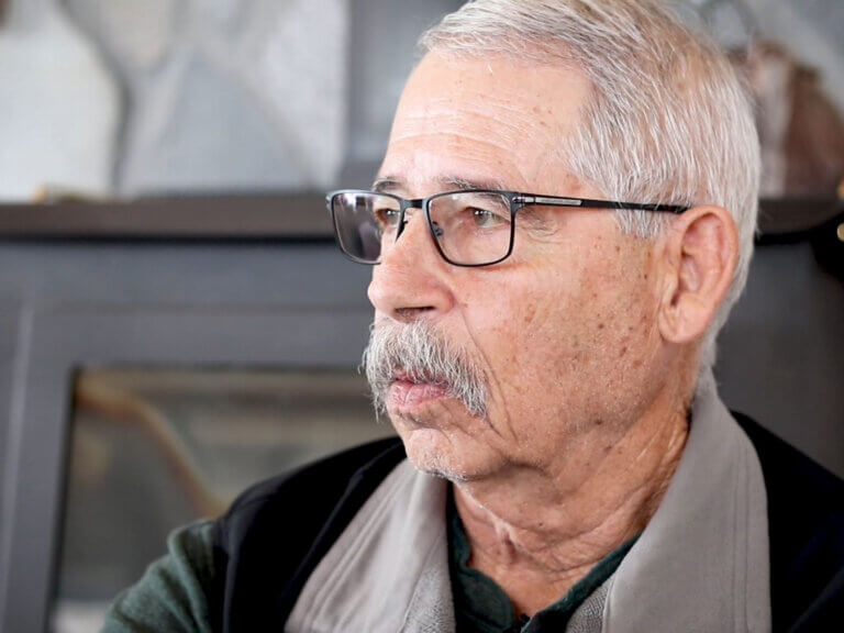 A landowner gives an interview after fire recovery