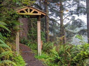 An ornamental gateway over the trail above the suspension bridge.