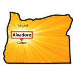 An illustration of Oregon in orange. Towards the center right of the state is a label for Alvadore, OR, framed with radiating yellow beams